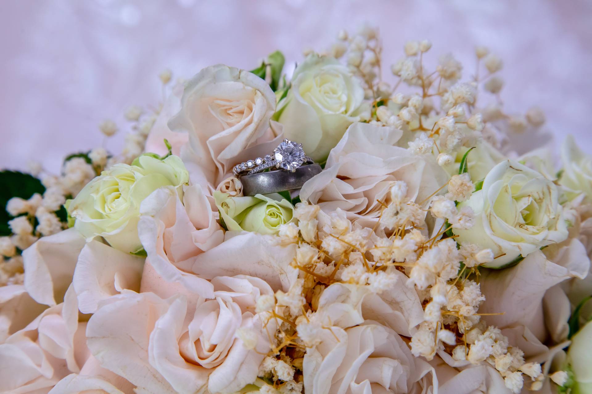 bride and grooms ring inside her bouquet