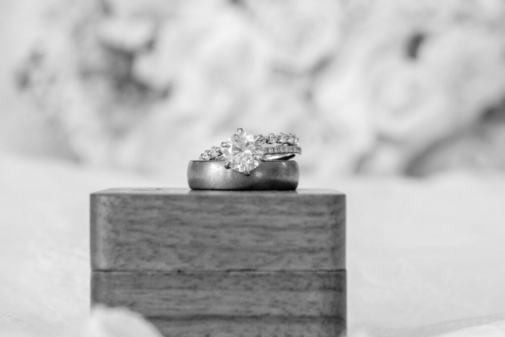 bride and grooms rings sitting on top of the wooden ring box