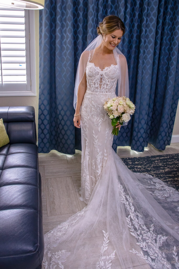 bride in her dress with flowers inside the hotel room