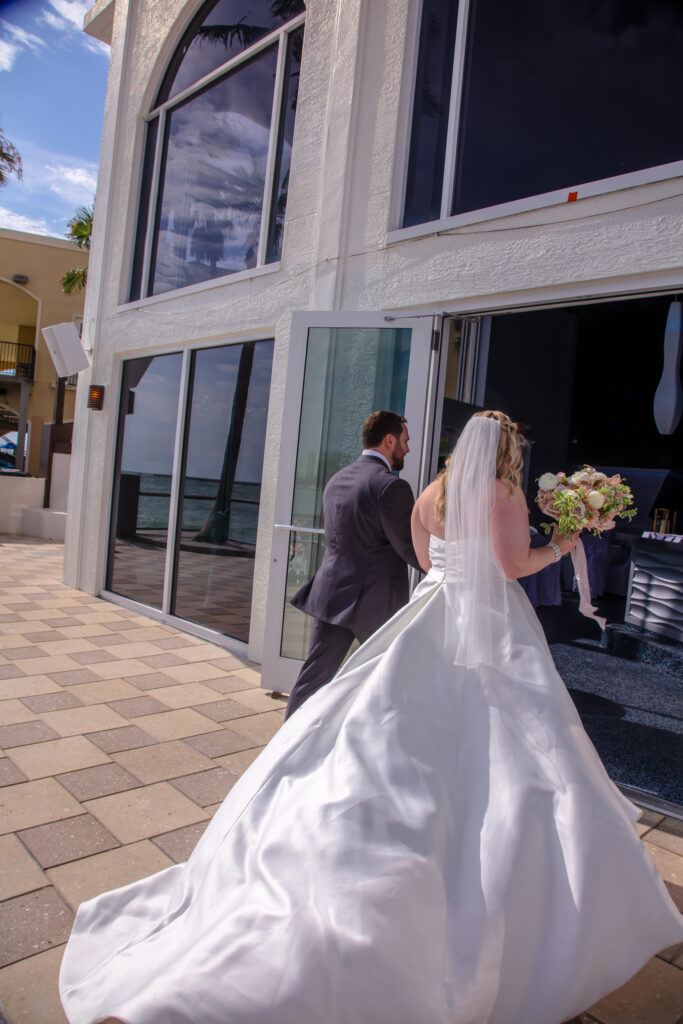 bride and groom entering their reception