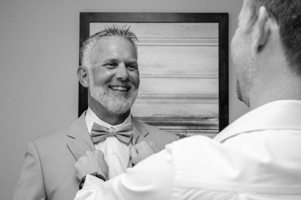 groom getting bow tie on