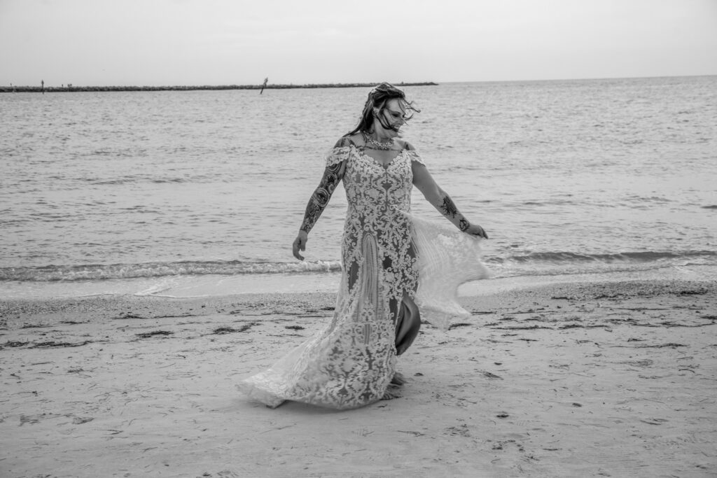 bride dancing by the water in her wedding dress